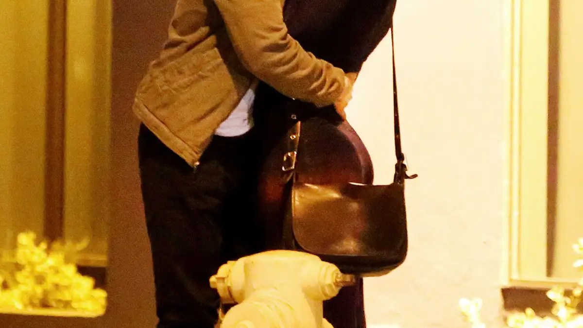 Owen Wilson and a woman kiss on October 7, 2013 in in Santa Monica