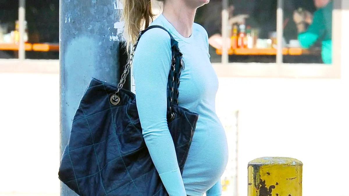 Emily Blunt shows off her growing baby bump as she goes to Hugo's