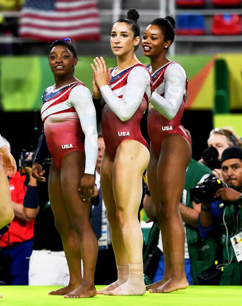 Simone Biles, Aly Raisman and Gabby Douglas of the United States celebrate winning the gold medal during the Artistic Gymnastics Women's Team Final on Day 4 of the Rio 2016 Olympic Games at the Rio Olympic Arena in Rio de Janeiro, Brazil.