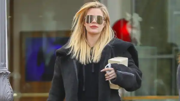 Khloe Kardashian hides her baby bump while out at Polacheck's Jewelers in Calabasas on December 23.