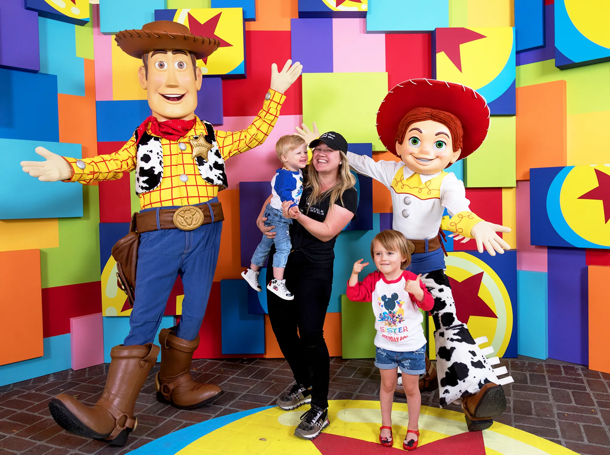 Kelly Clarkson and her children, Remy and River visit with Pixar pals Woody and Jessie at the launch of Pixar Fest at the Disneyland Resort in Anaheim, California.