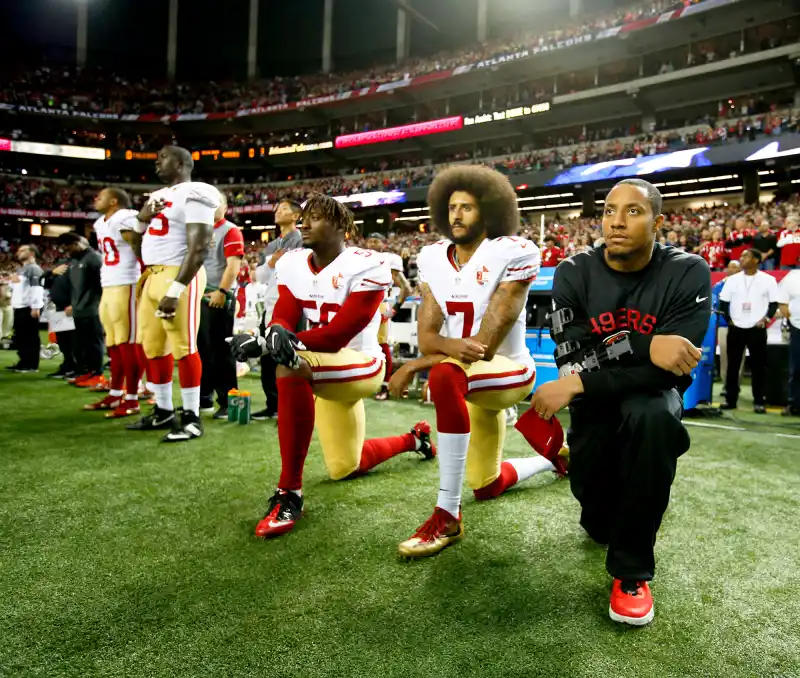 Colin Kaepernick #7 of the San Francisco 49ers kneel on the sideline, during the anthem, prior to the game against the Atlanta Falcons at the Georgia Dome on December 18, 2016 in Atlanta, Georgia.