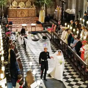 Britain's Prince Harry, Duke of Sussex (L) and Britain's Meghan Markle, Duchess of Sussex, (R) walk away from the High Altar