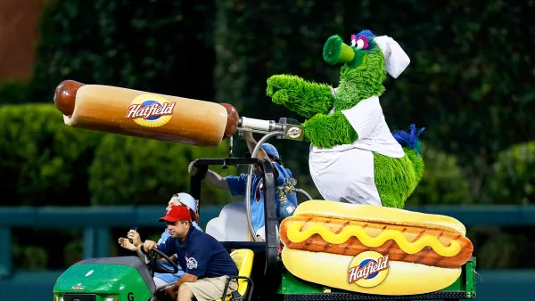 The Philadelphia Phillies mascot the Phillie Phanatic rides a Hatfield Hot Dog cart in the outfield during the game in Philadelphia, Pennsylvania.