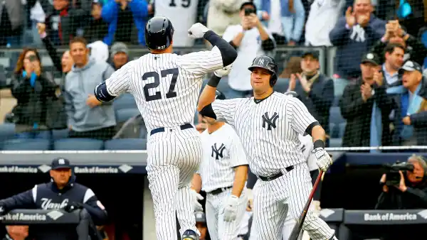 Giancarlo Stanton #27 of the New York Yankees celebrates his first inning two run home run against the Tampa Bay Rays with teammate Gary Sanchez #24 at Yankee Stadium on April 4, 2018 in the Bronx borough of New York City.