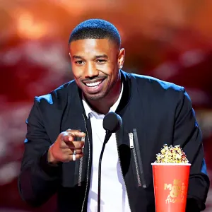 Michael B. Jordan accepts the Best Villain award for 'Black Panther' onstage during the 2018 MTV Movie And TV Awards at Barker Hangar on June 16, 2018 in Santa Monica, California.