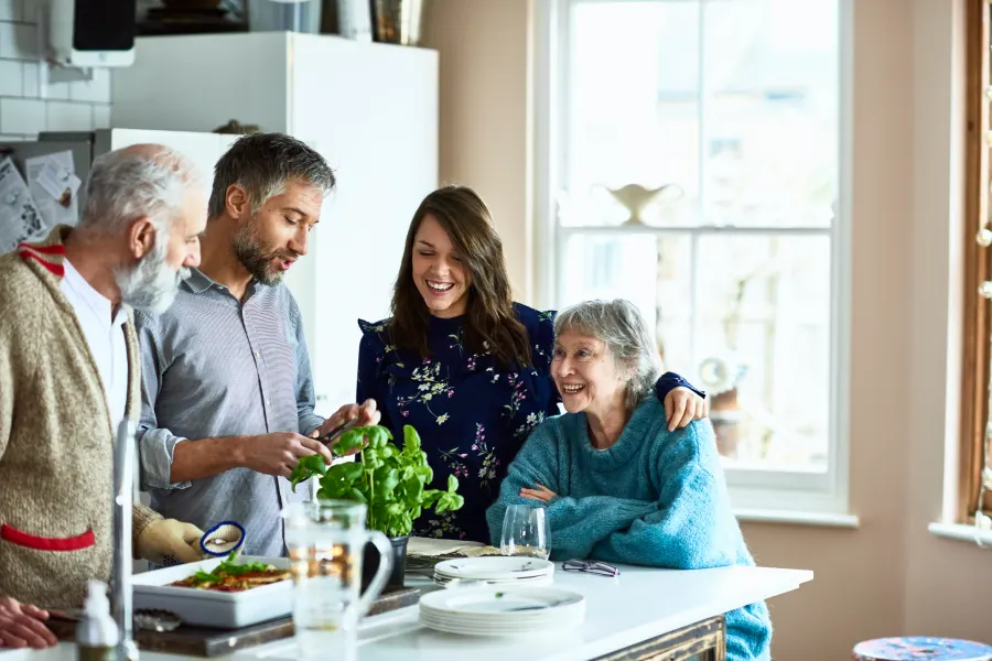Couple hosting their parents and in laws for dinner in family home
