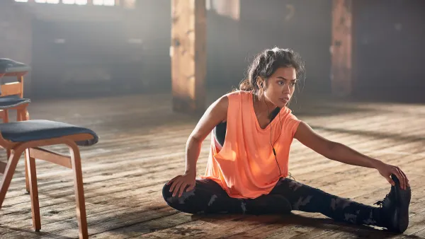 Woman stretching with earbuds