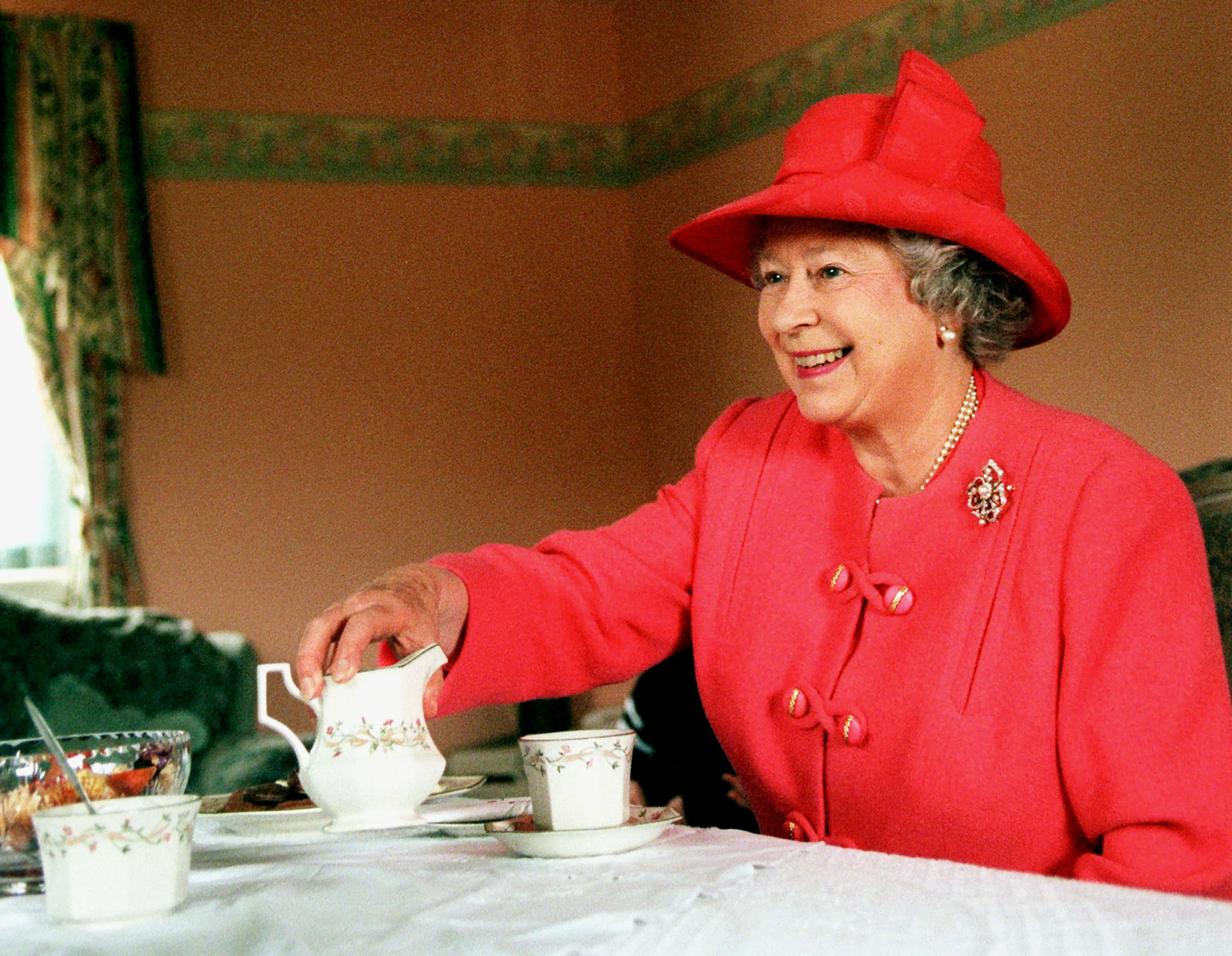 Queen Elizabeth drinking tea