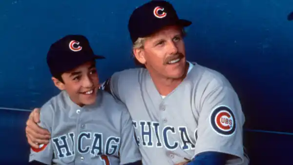 Thomas Ian Nicholas on dugout bench with Gary Busey in a scene from the film 'Rookie Of The Year', 1993.