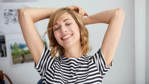 woman relaxing sitting down in her chair with striped shirt