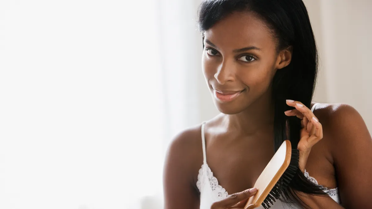 black woman brushing her hair
