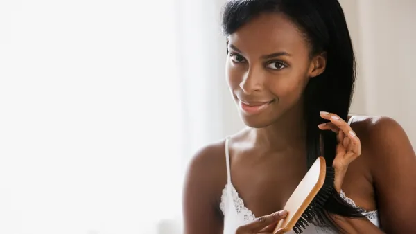 black woman brushing her hair
