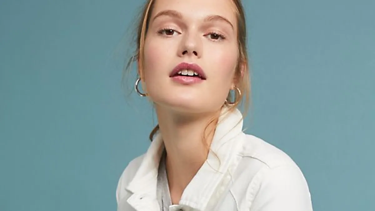 white denim jacket with black tassels and embroidery