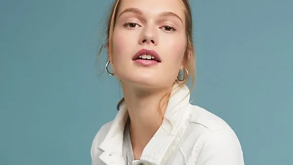 white denim jacket with black tassels and embroidery