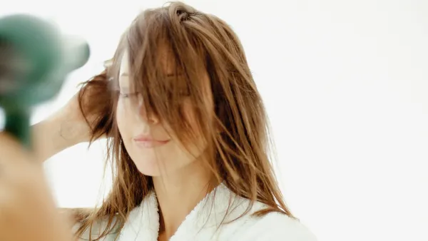 Woman blow-drying hair