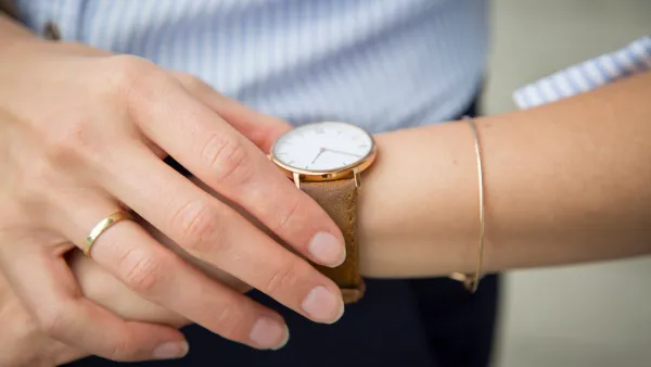 Businesswoman wearing wrist watch, close-up