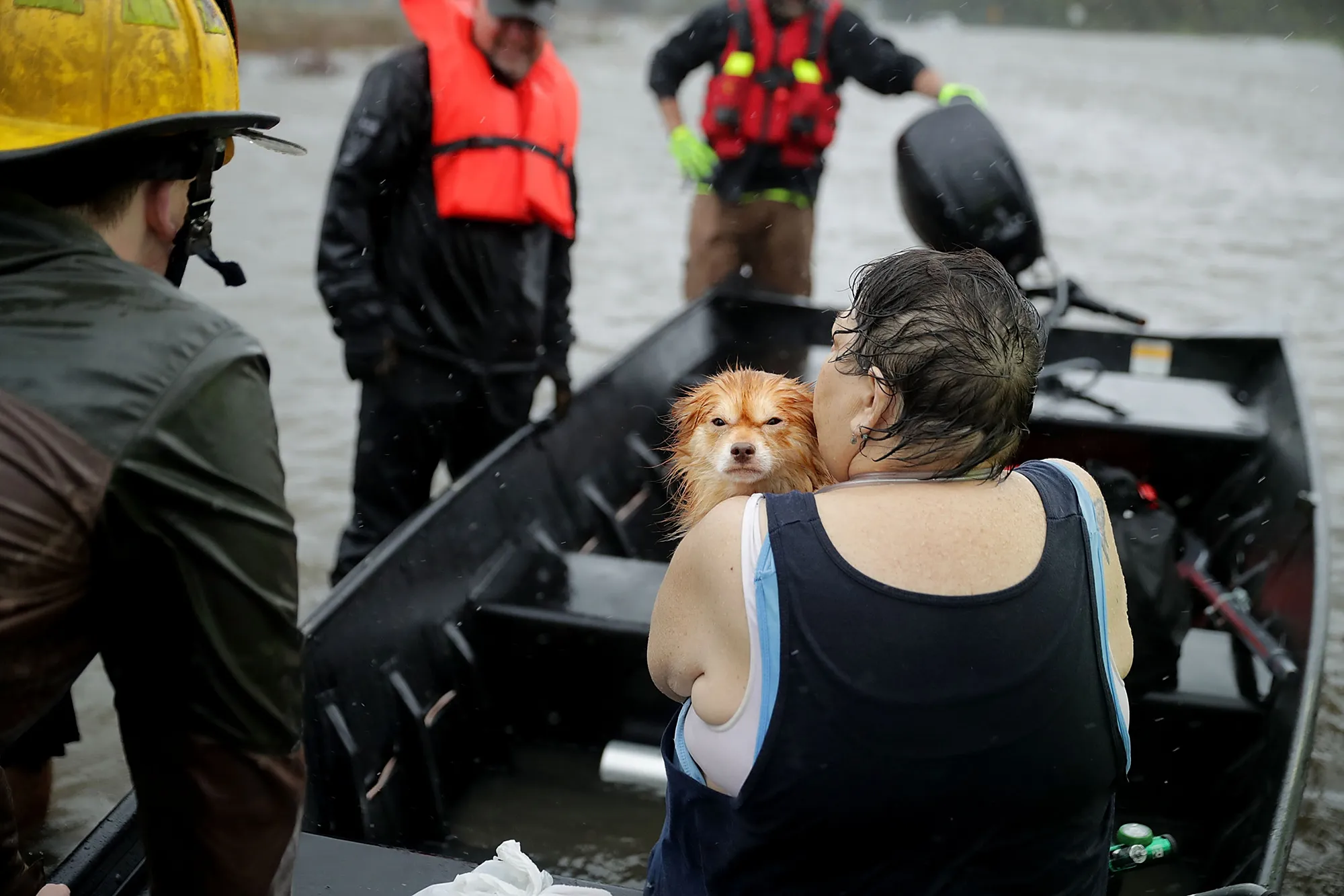 Rescue workers from Township No. 7 Fire Department and volunteers from the Civilian Crisis Response Team use a boat to rescue a woman and her dog from their flooded home during Hurricane Florence