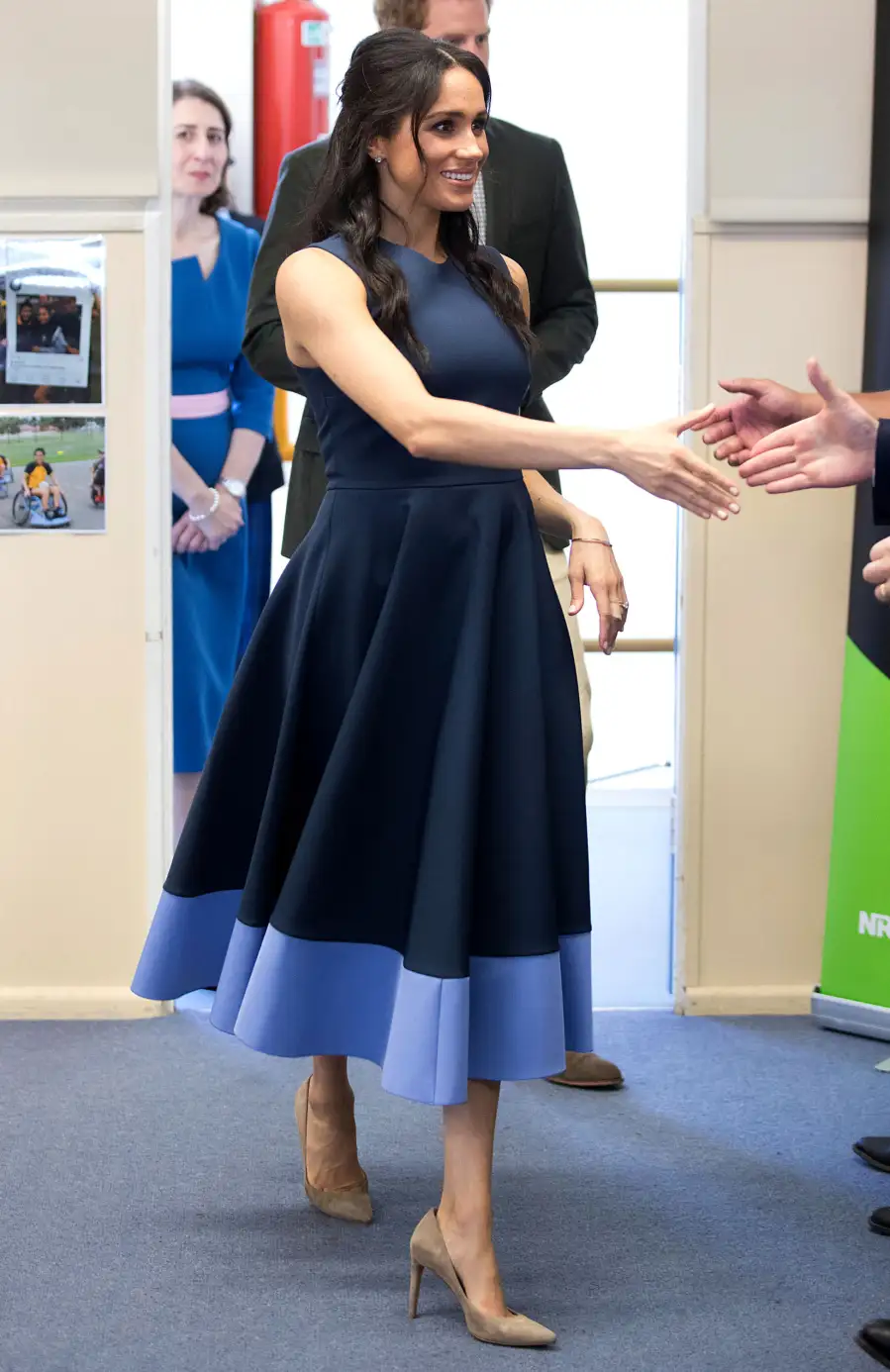 Pregnant Meghan Markle Shows Off Baby Bump