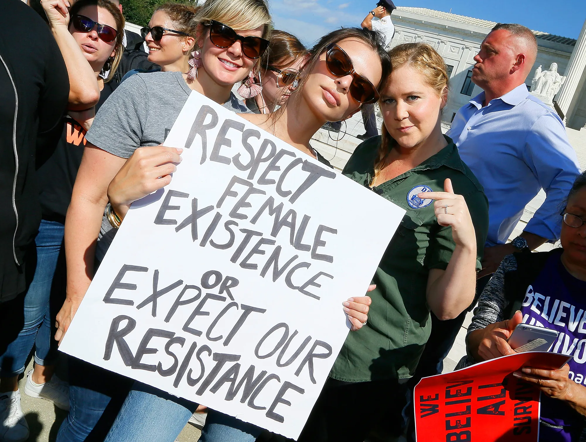 Emily Ratajkowski (C) and Amy Schumer (R) join the Brett Kavanaugh U.S. Supreme Court Confirmation Protest in front of the Supreme Court on October 4, 2018 in Washington, DC.