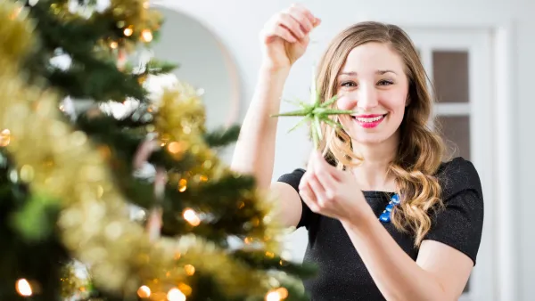woman decorating christmas tree