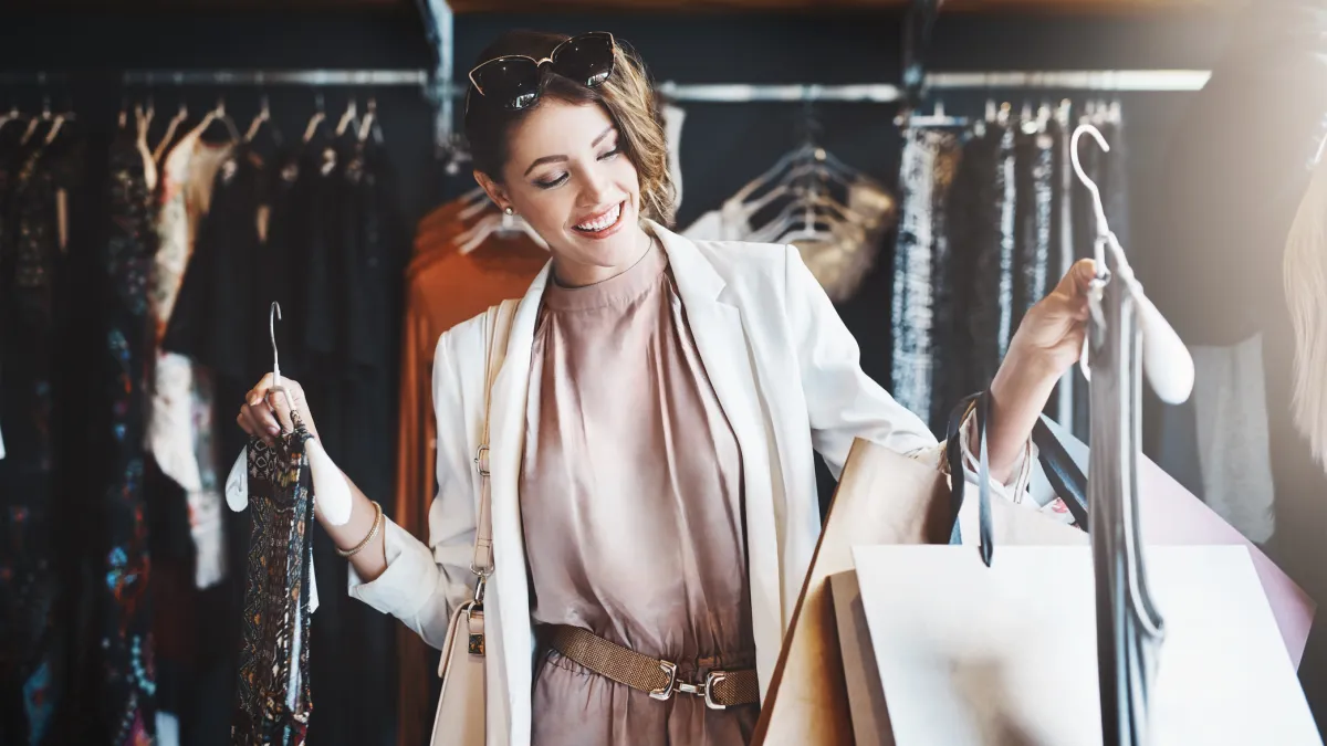Shot of a young woman looking at a few items in a boutique