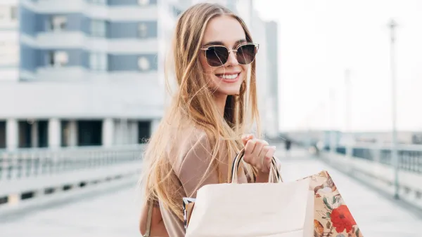 Portrait of a smiling woman carrying shopping bags
