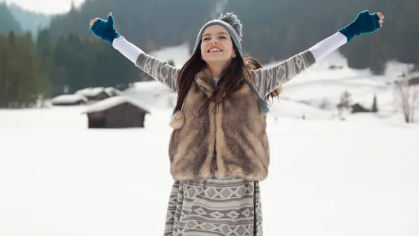 woman in the snow wearing a fur vest