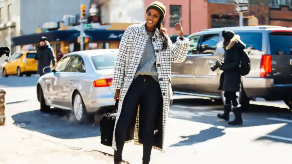 model in skinny jeans and checkered coat