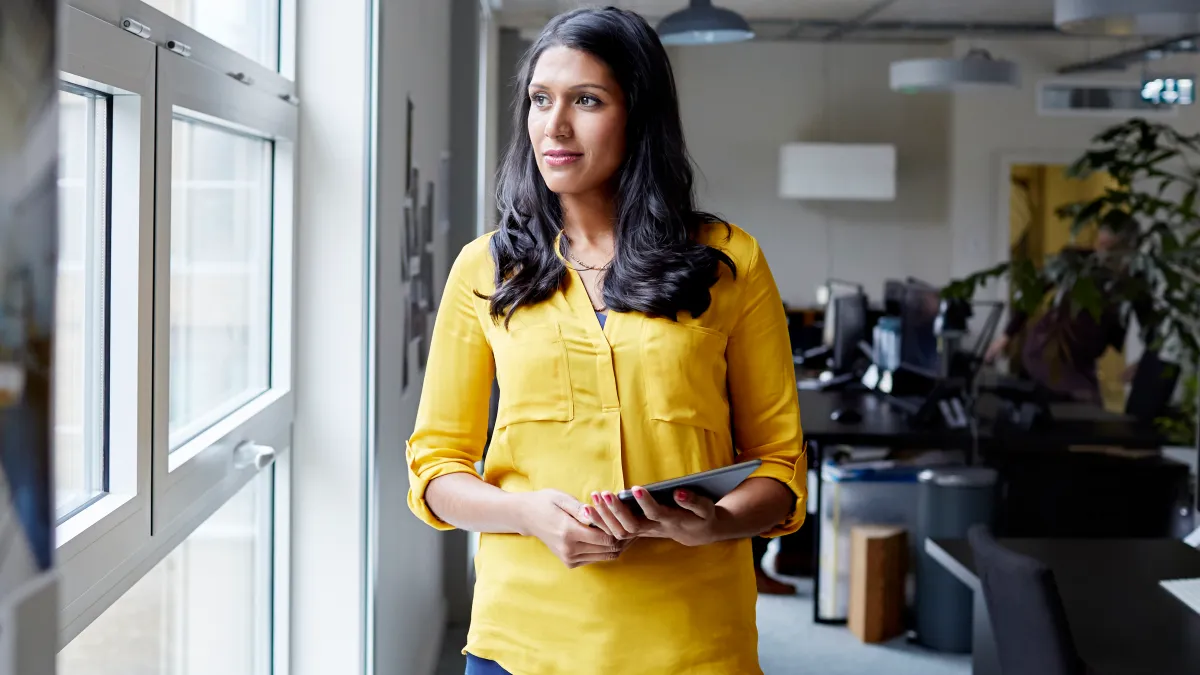 Portrait of a female office worker with tablet