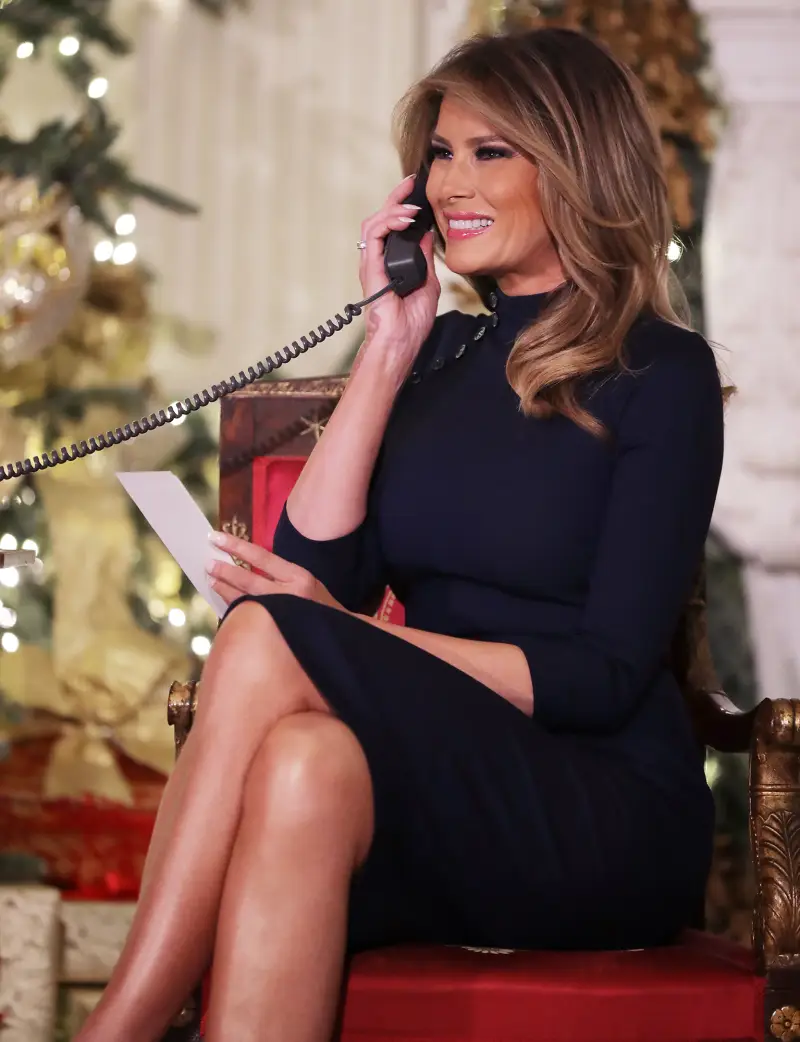Melania Trump Christmas Eve manning the phones of the NORAD Santa tracker in a navy blue Ralph Lauren turtleneck dress