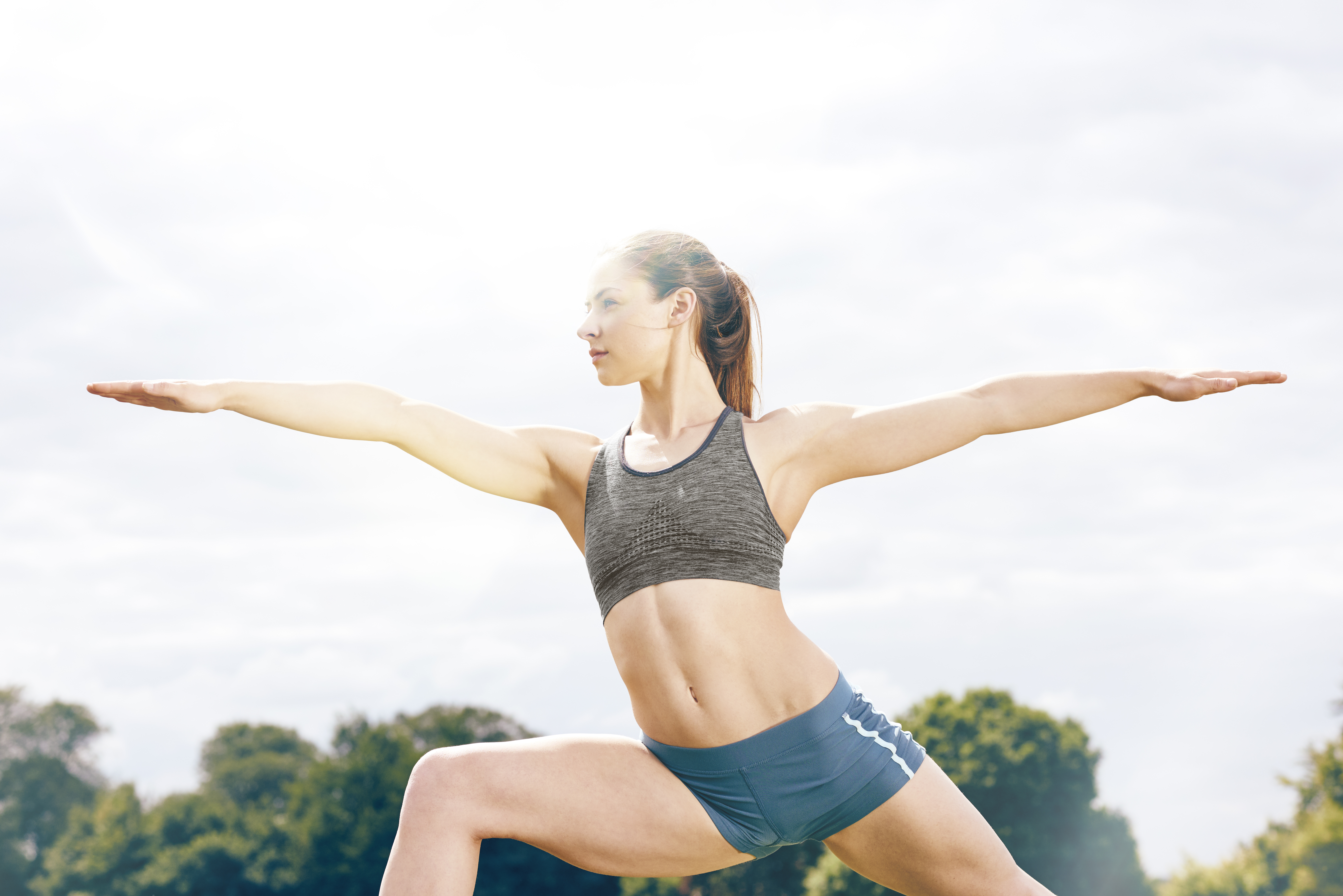 healthy female athlete in deep yoga pose