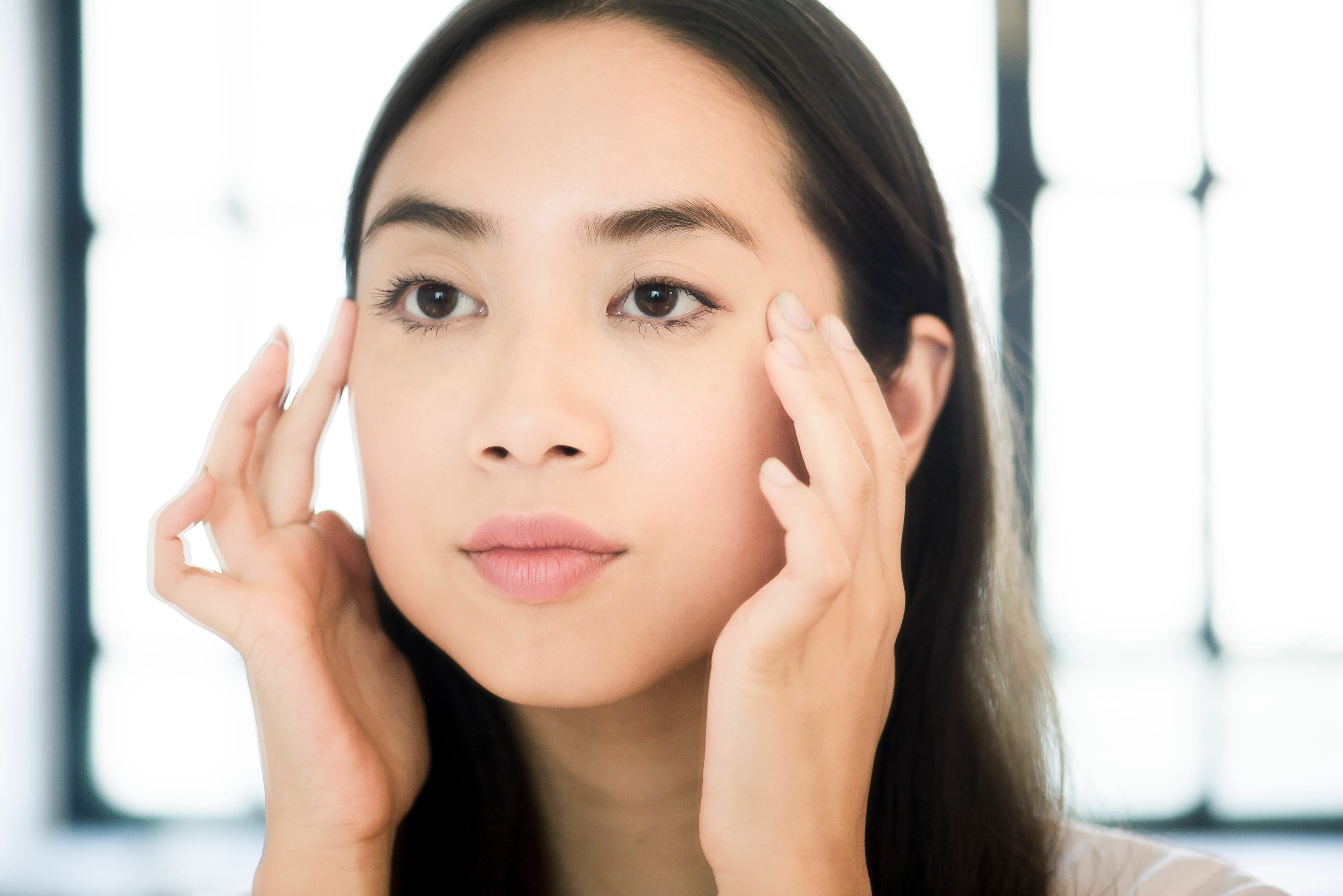 woman massaging face