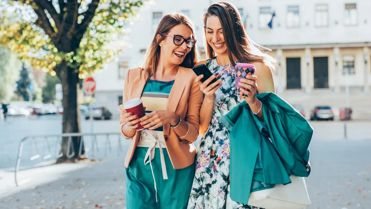 friends walking with shopping bags