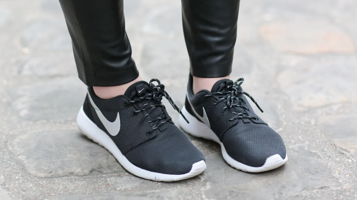 woman in nike roshe sneakers