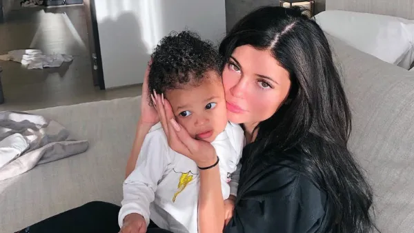 Kylie Jenner Shows Support for Travis Scott While Cuddling Stormi