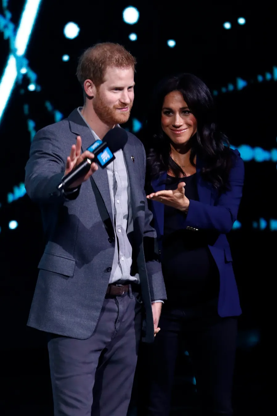 Prince Harry Surprises Crowd and Drags Pregnant Wife Duchess Meghan on Stage at Charity Event