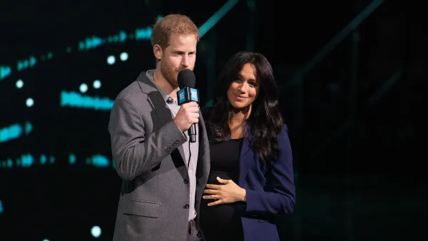 Prince Harry Surprises Crowd and Drags Pregnant Wife Duchess Meghan on Stage at Charity Event