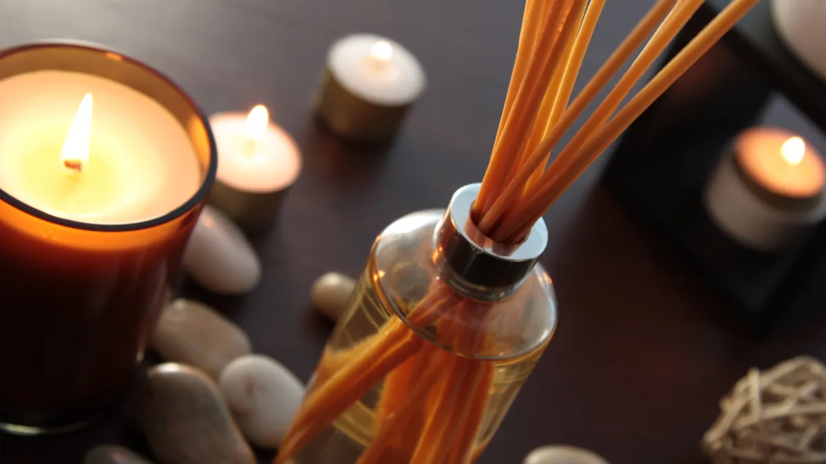 Close up of a bottle of fragrance diffuser with reeds.