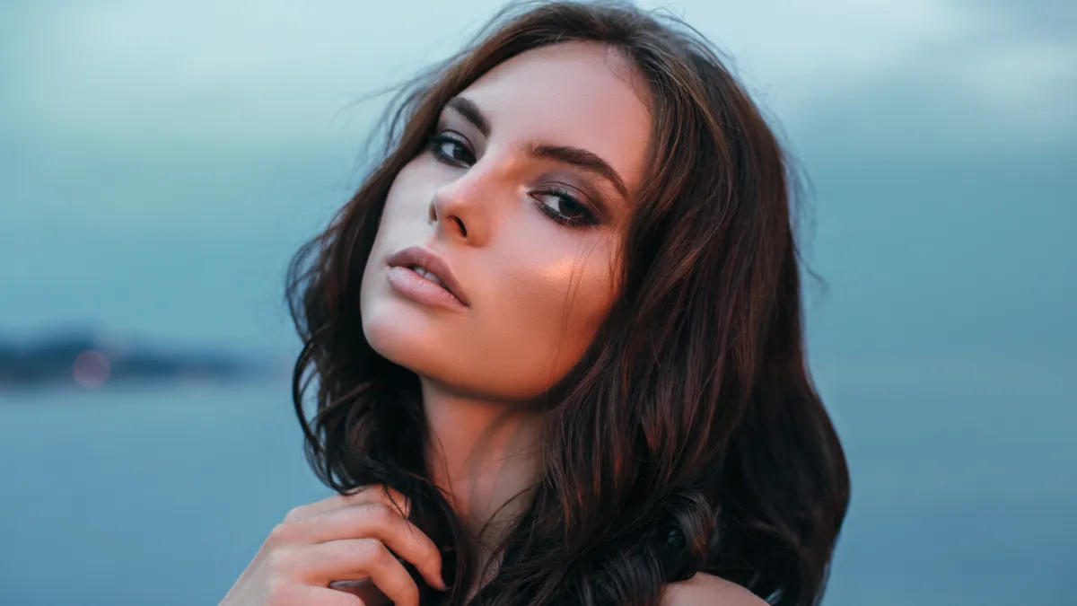 Portrait of a fresh and lovely woman posing at the beach