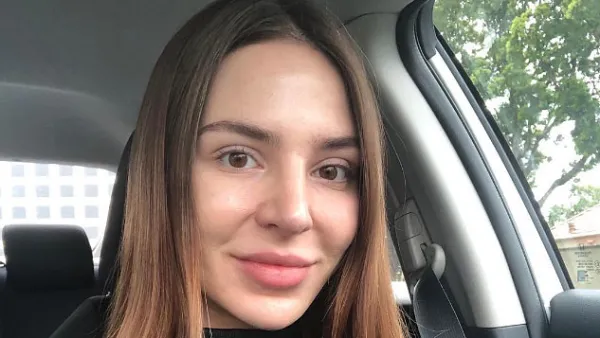Anfisa Nava Sitting In Her Car Wearing A Green Shirt