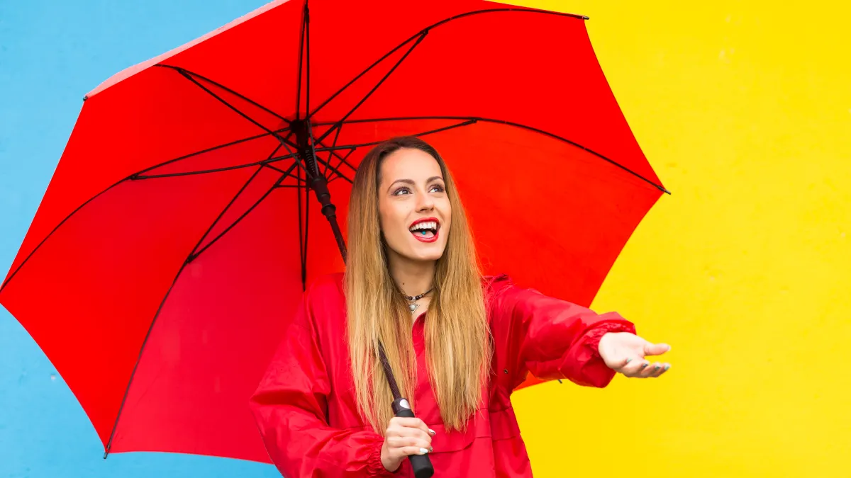 Young woman holding red umbrella