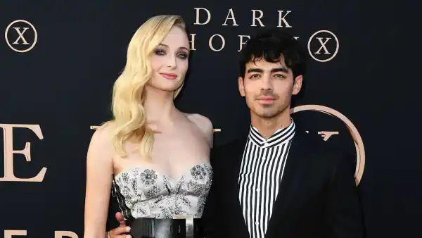 Sophie Turner Black and White Stripe Dress and Joe Jonas Black Jacket Black Pants Black and White Stripe Shirt Ring X Men Dark Phoenix
