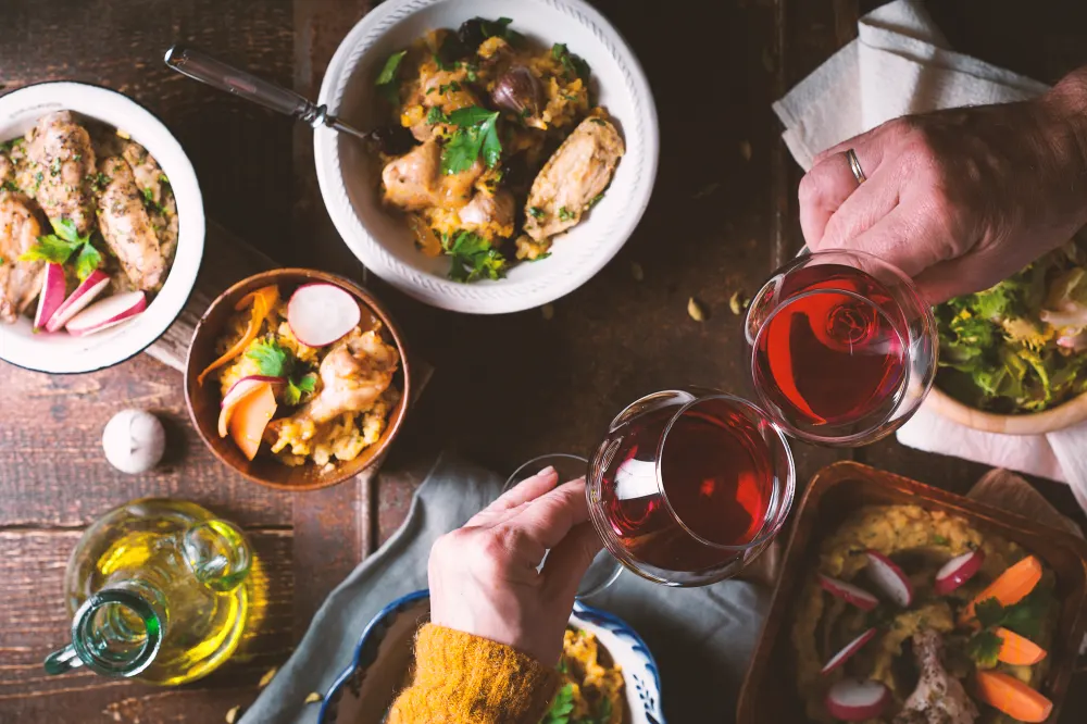 Pilaf, vegetable salad and a drink on the holiday table