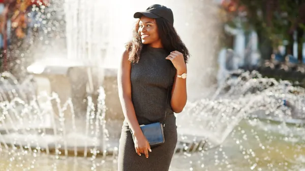 girl standing in front of a fountain