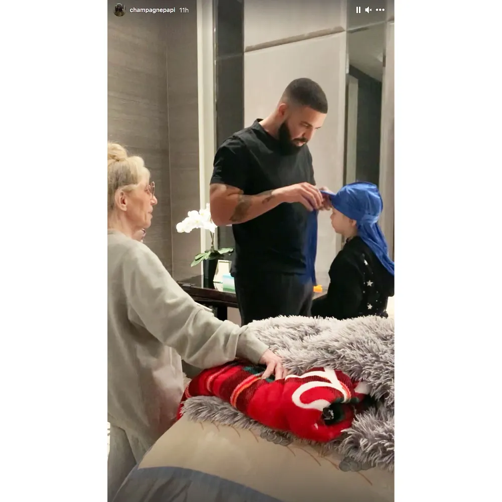 Drake Helps His Son Adonis Get Dressed