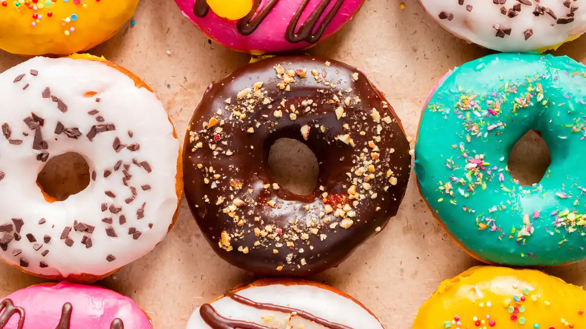 tasty donuts on paper close up