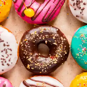 tasty donuts on paper close up