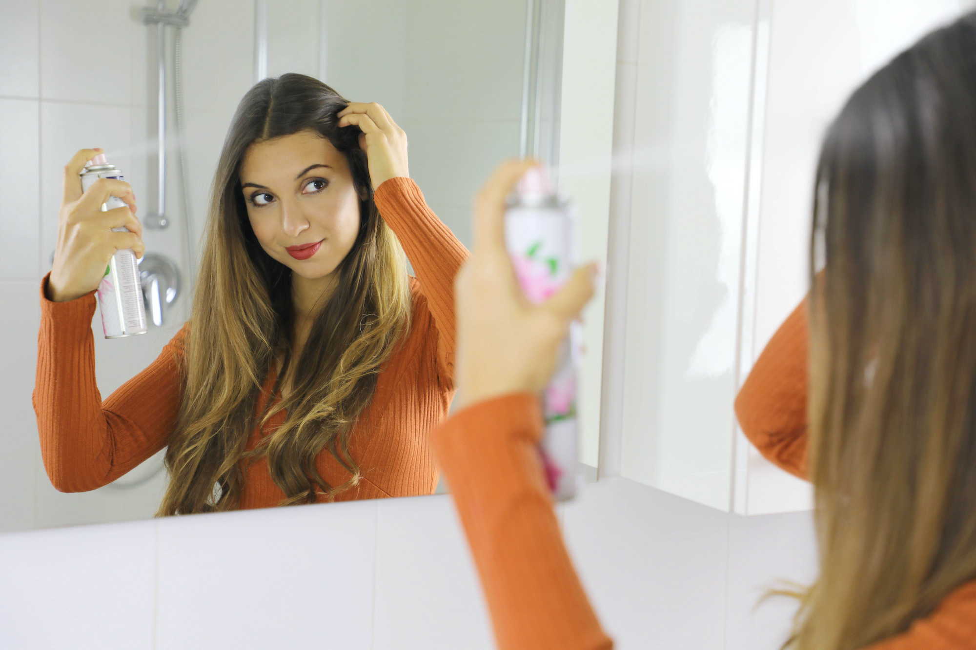 Woman-Using-Dry-Shampoo-Stock-Photo