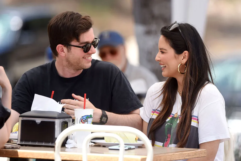 Pregnant Olivia Munn Shows Baby Bump Progress in New Photo With John Mulaney Eating Smile Sunglasses Hoop Earring